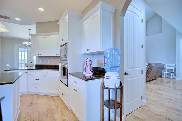 a kitchen with stainless steel appliances kitchen island granite countertop a stove a sink and a refrigerator