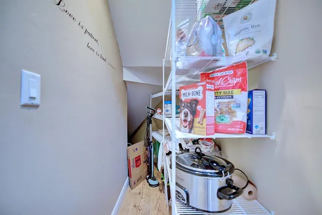 a room with storage and a white wall