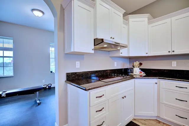 a kitchen with stainless steel appliances granite countertop a sink a stove and cabinets