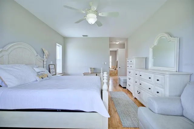 a bathroom with a granite countertop tub sink and mirror