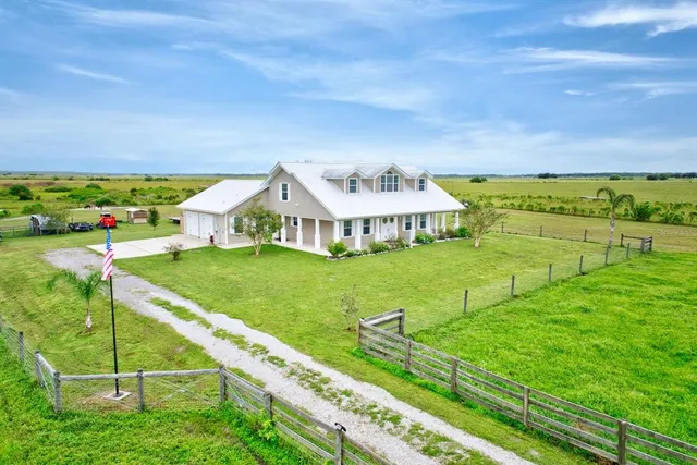 a view of an house with backyard outdoor seating and hardwood