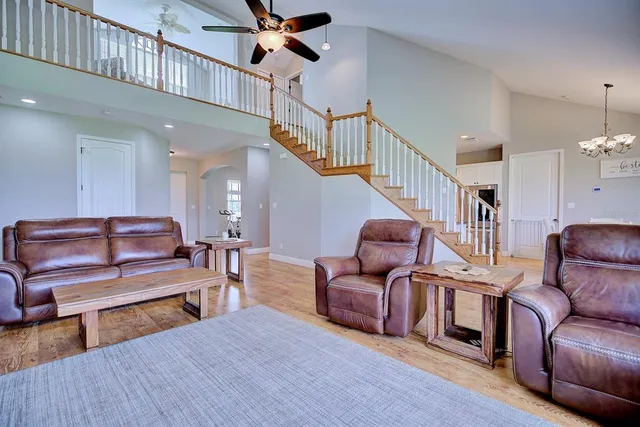 a living room with furniture ceiling fan and a rug