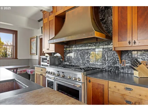 a kitchen with stainless steel appliances granite countertop a stove and a sink