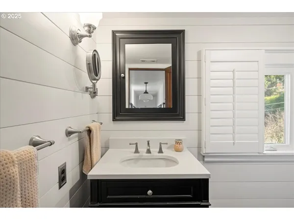 a bathroom with a sink vanity and a mirror