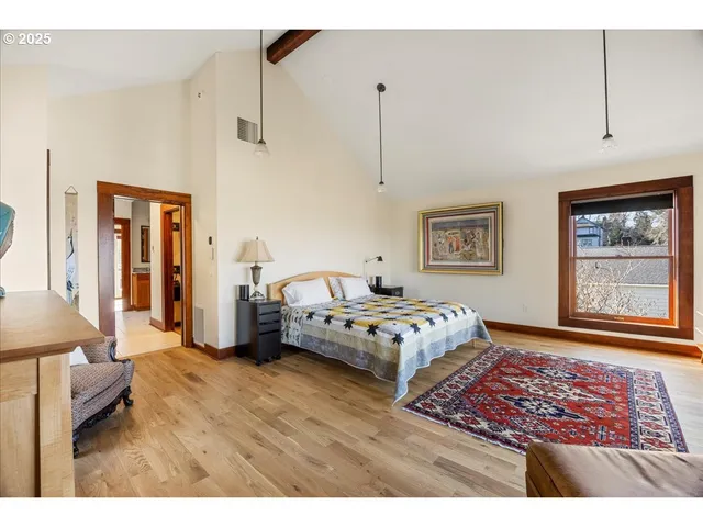 a bedroom with a bed and a painting on the wall