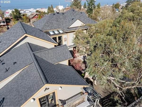 an aerial view of a house with a yard