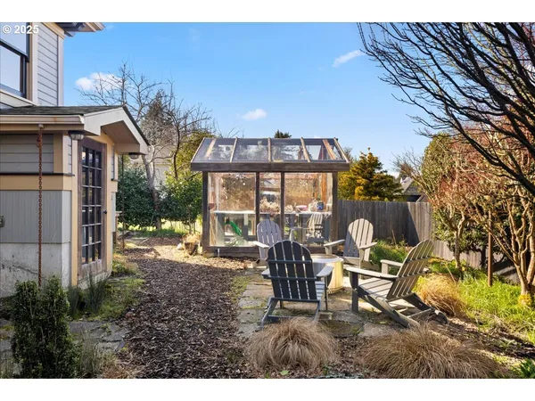 a backyard of a house with table and chairs