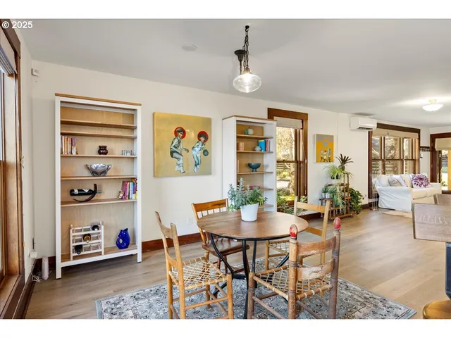 a dining room with furniture and a window