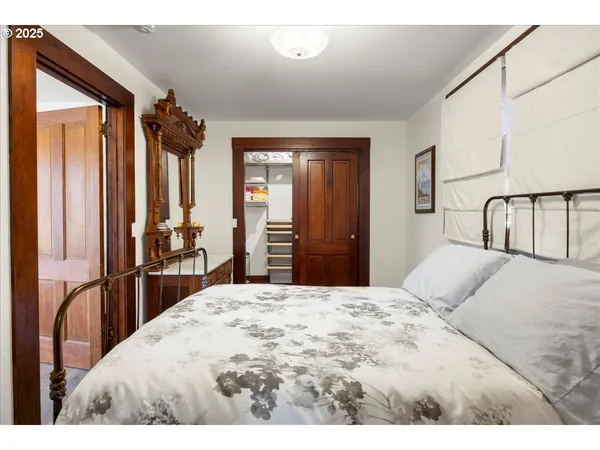 a bedroom with a large bed and a dresser