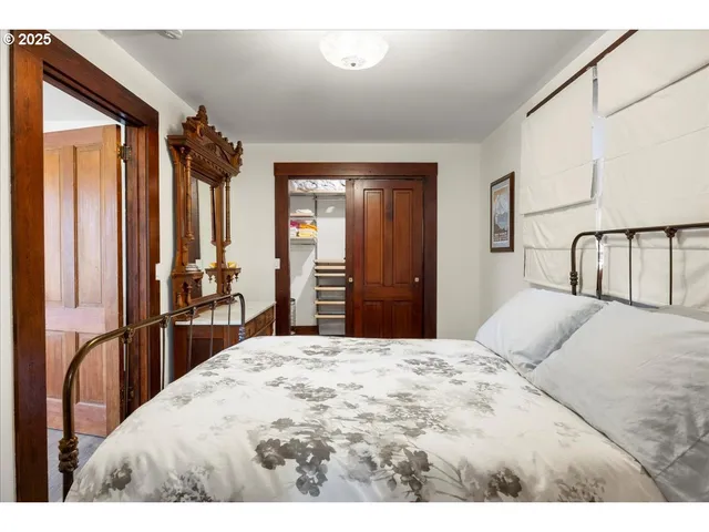 a bedroom with a large bed and a dresser