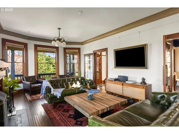 a living room with furniture a flat screen tv and a large window