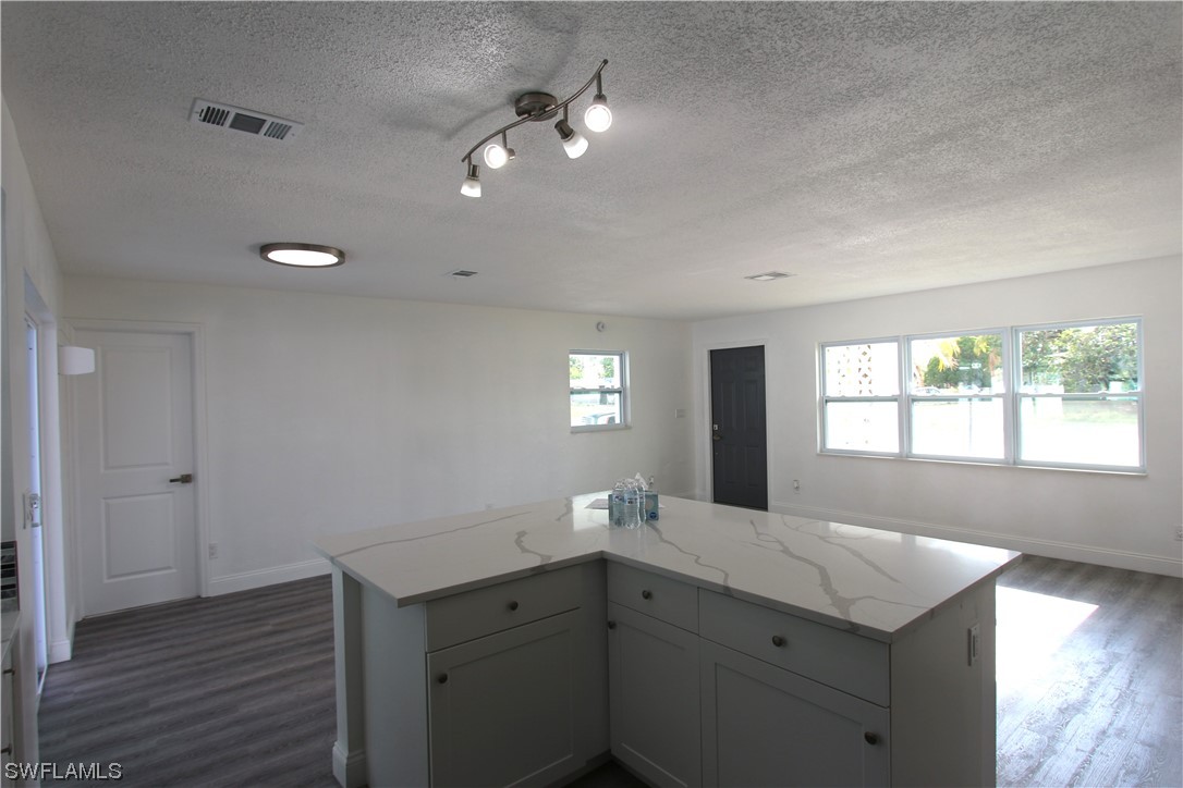 116 Oleander Road Lehigh Acres, FL 33936 - Photo 11 of 31 a bathroom with a sink a vanity and a large mirror