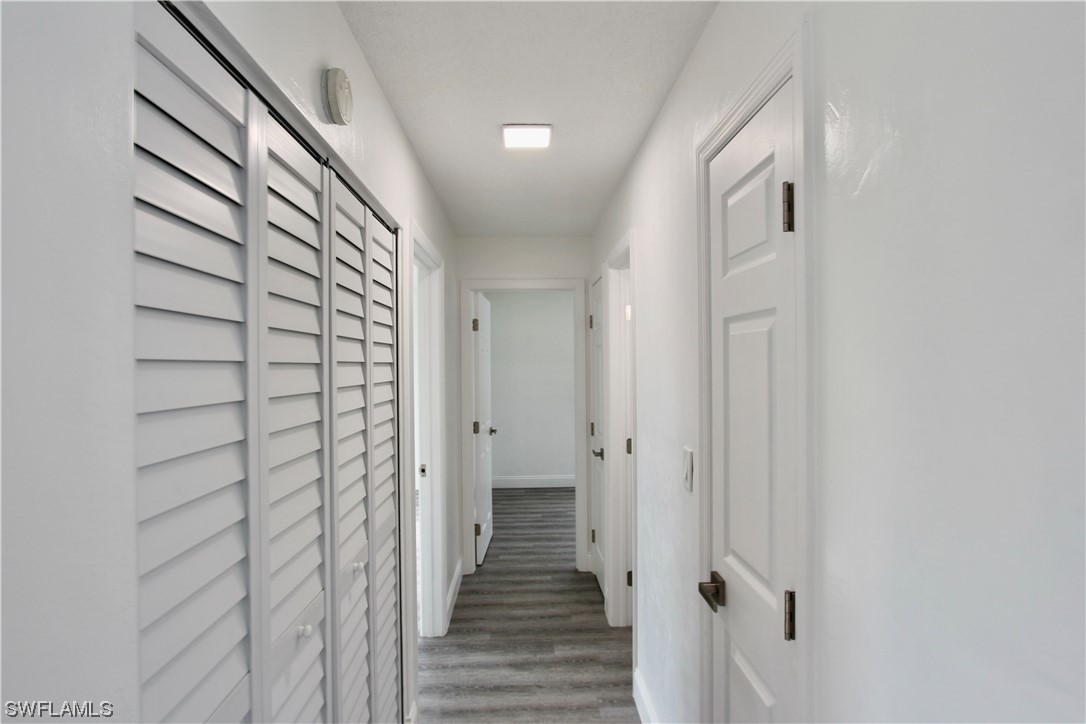116 Oleander Road Lehigh Acres, FL 33936 - Photo 12 of 31 a view of a hallway with wooden floor and staircase