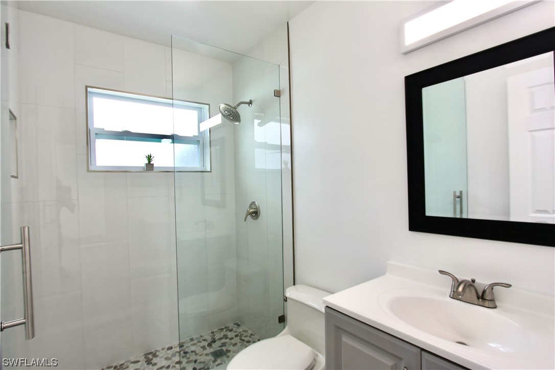 116 Oleander Road Lehigh Acres, FL 33936 - Photo 18 of 31 a bathroom with a sink and a mirror
