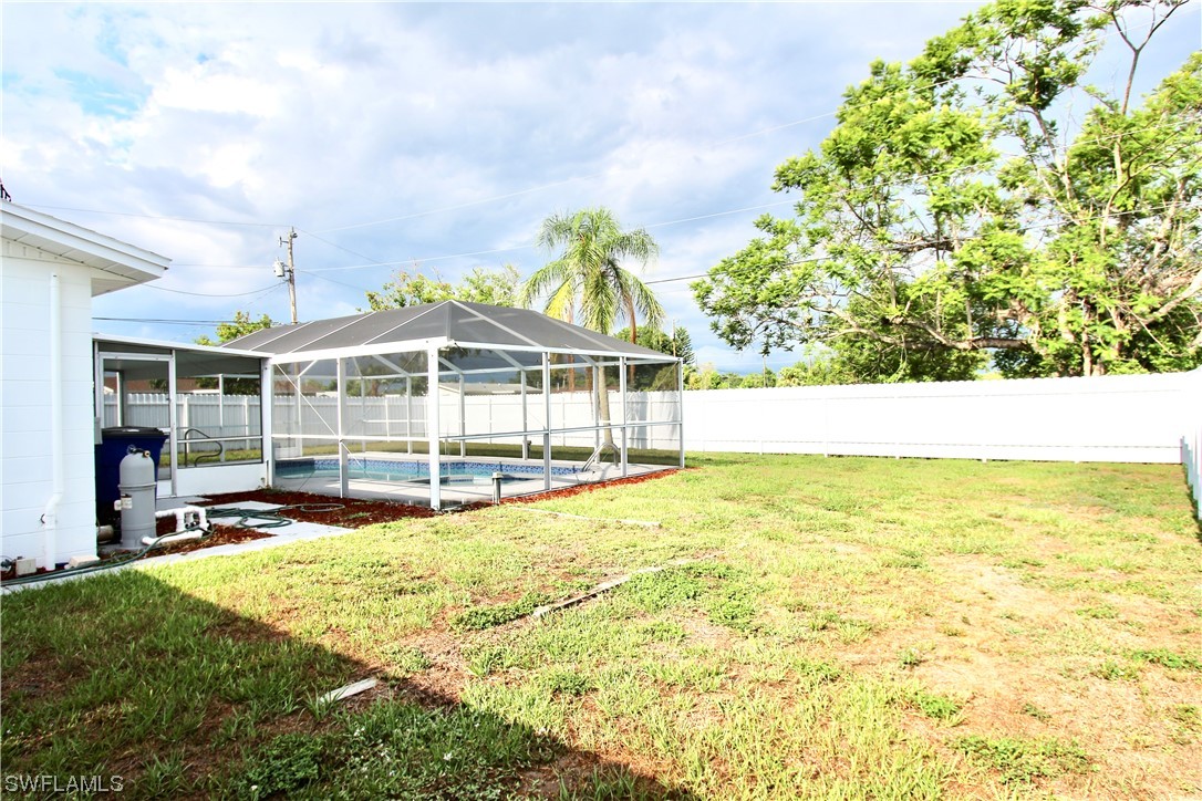 116 Oleander Road Lehigh Acres, FL 33936 - Photo 28 of 31 a view of a swimming pool with an outdoor space and seating area