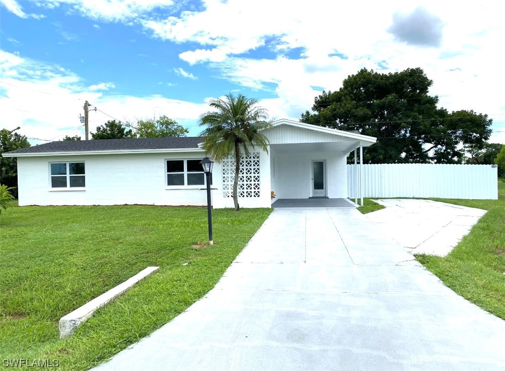 116 Oleander Road Lehigh Acres, FL 33936 - Photo 3 of 31 a front view of house with yard and green space