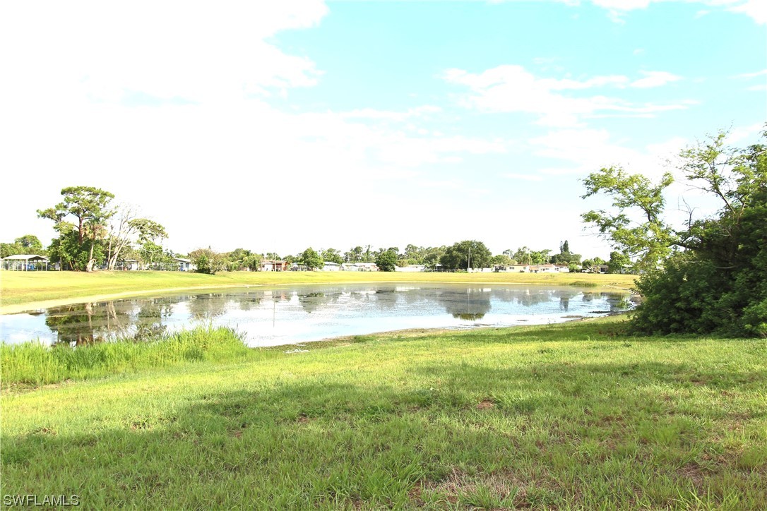 116 Oleander Road Lehigh Acres, FL 33936 - Photo 31 of 31 a view of a lake with houses in the back