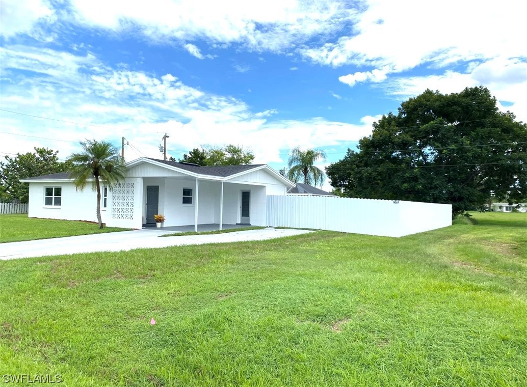 116 Oleander Road Lehigh Acres, FL 33936 - Photo 4 of 31 a view of an house with backyard space and balcony
