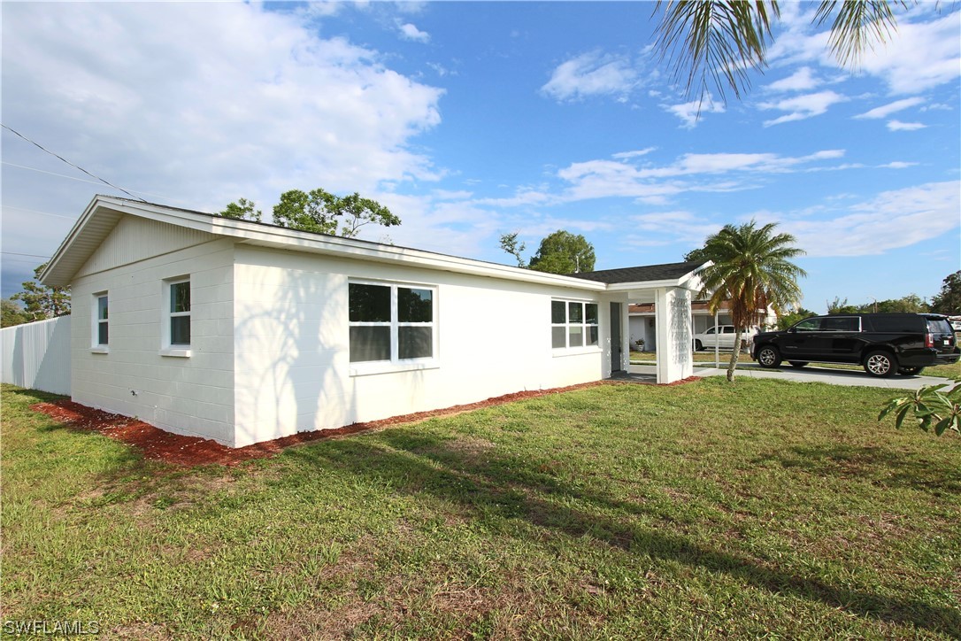 116 Oleander Road Lehigh Acres, FL 33936 - Photo 5 of 31 a view of a house with a yard