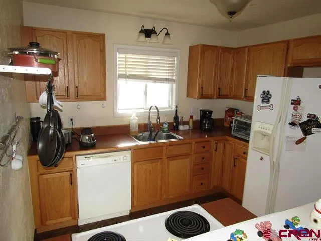 a kitchen with a sink stove and refrigerator