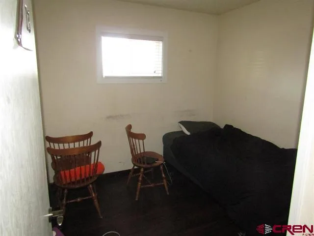 a view of a room with furniture and wooden floor