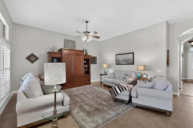 a living room with furniture and a painting on the wall