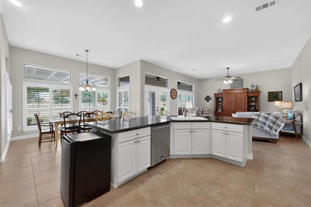 a kitchen with white cabinets appliances and a sink