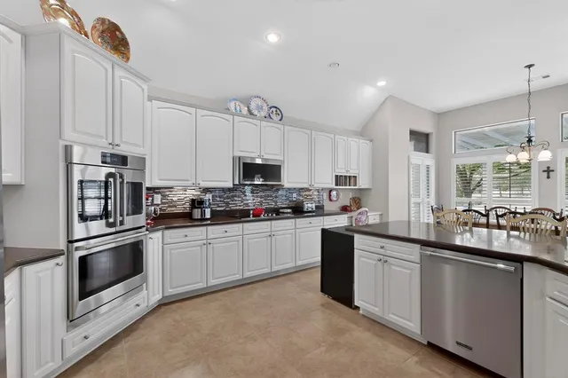 a kitchen with a stove and a refrigerator