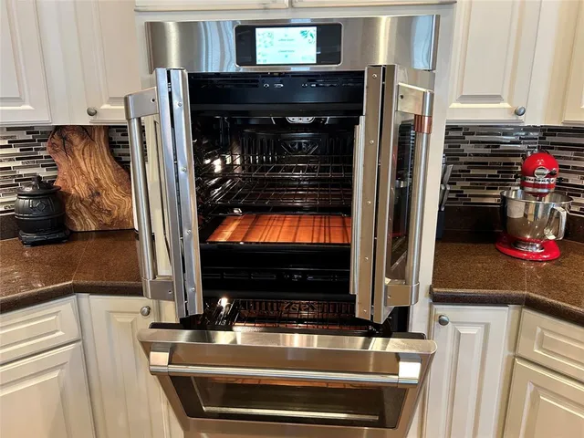 a kitchen with stainless steel appliances granite countertop a stove and a refrigerator