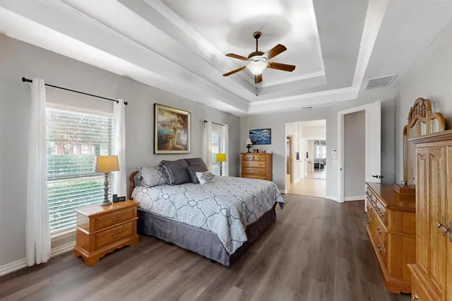 a spacious en suite bathroom with a double vanity sink and a mirror