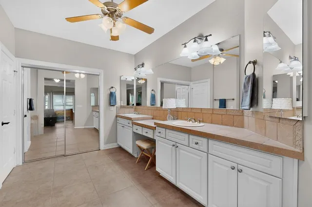 a hall with a sink and cabinets