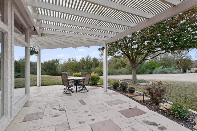 a view of a patio with a table chairs and backyard