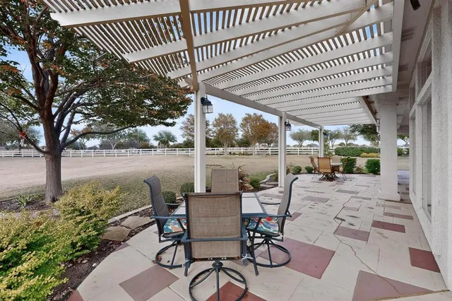 a view of a house with backyard porch and sitting area