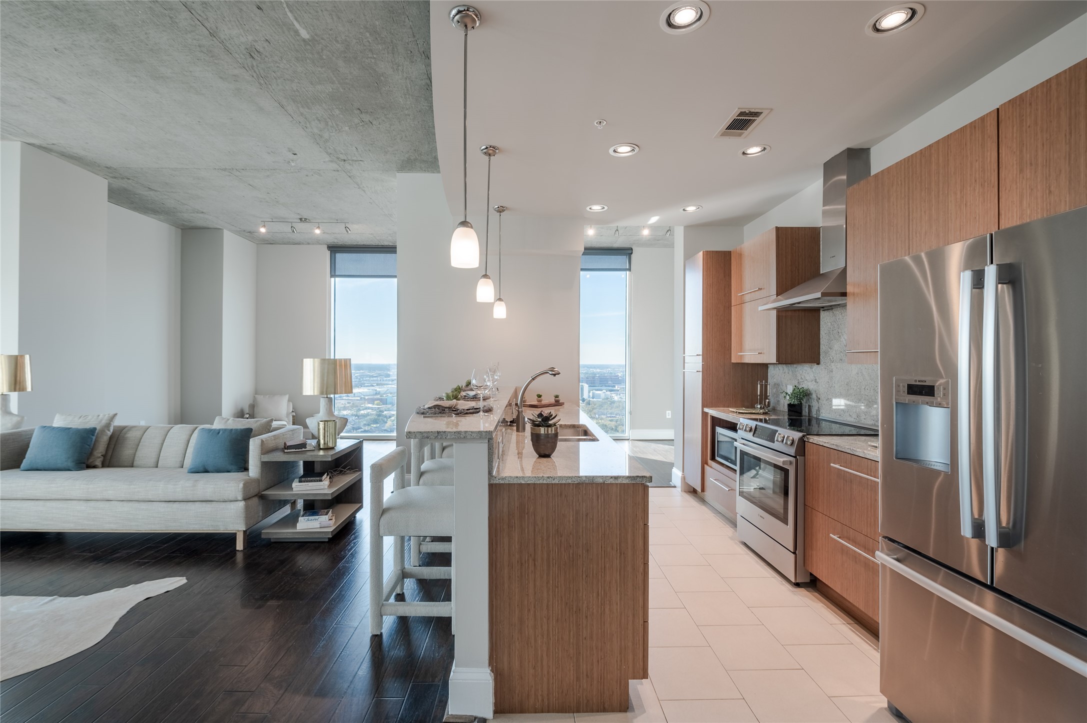 a living room with kitchen island furniture and a kitchen view