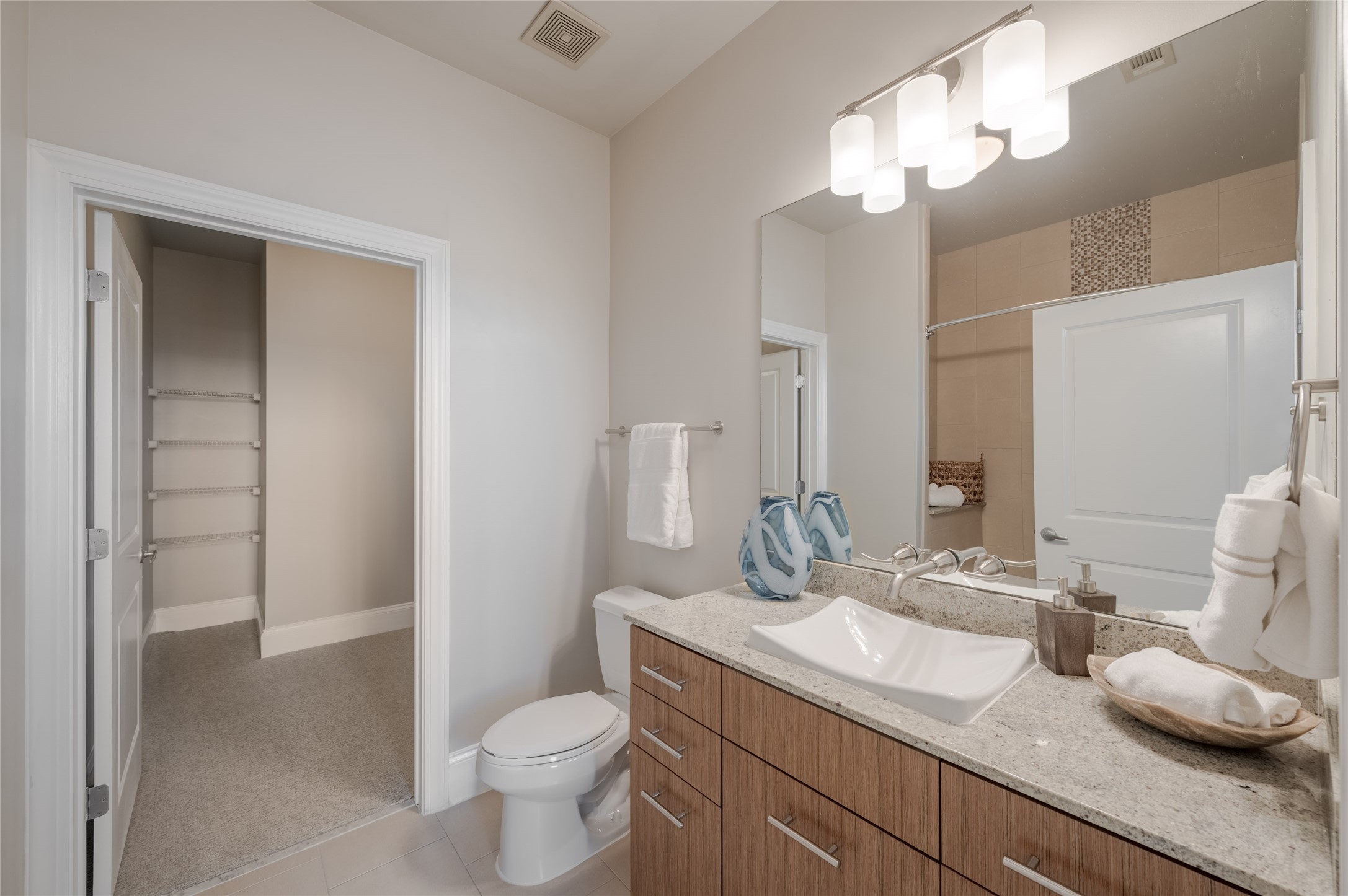 5927 Almeda Road, Unit 22903 Houston, TX 77004 - Photo 10 of 13 a bathroom with a granite countertop sink a toilet and a mirror