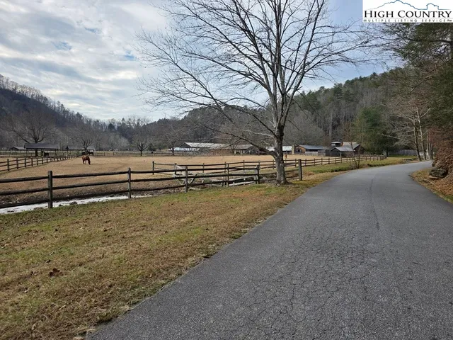 a view of a yard with wooden fence