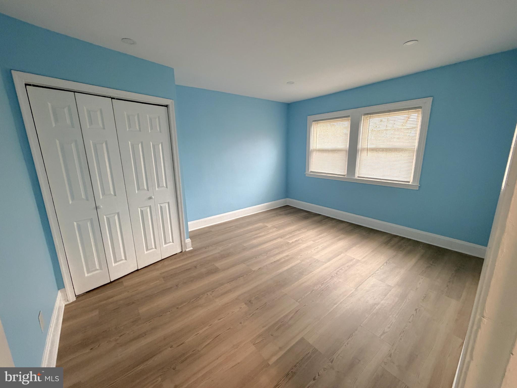 12 South Ellamont Street Baltimore, MD 21229 - Photo 12 of 26 an empty room with wooden floor and windows