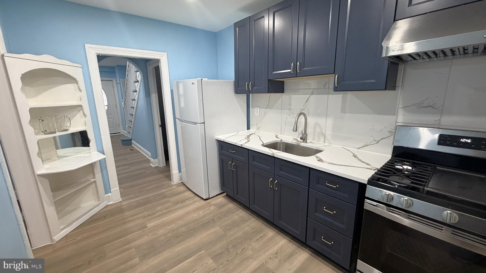 12 South Ellamont Street Baltimore, MD 21229 - Photo 3 of 26 a kitchen with stainless steel appliances granite countertop a refrigerator and a sink
