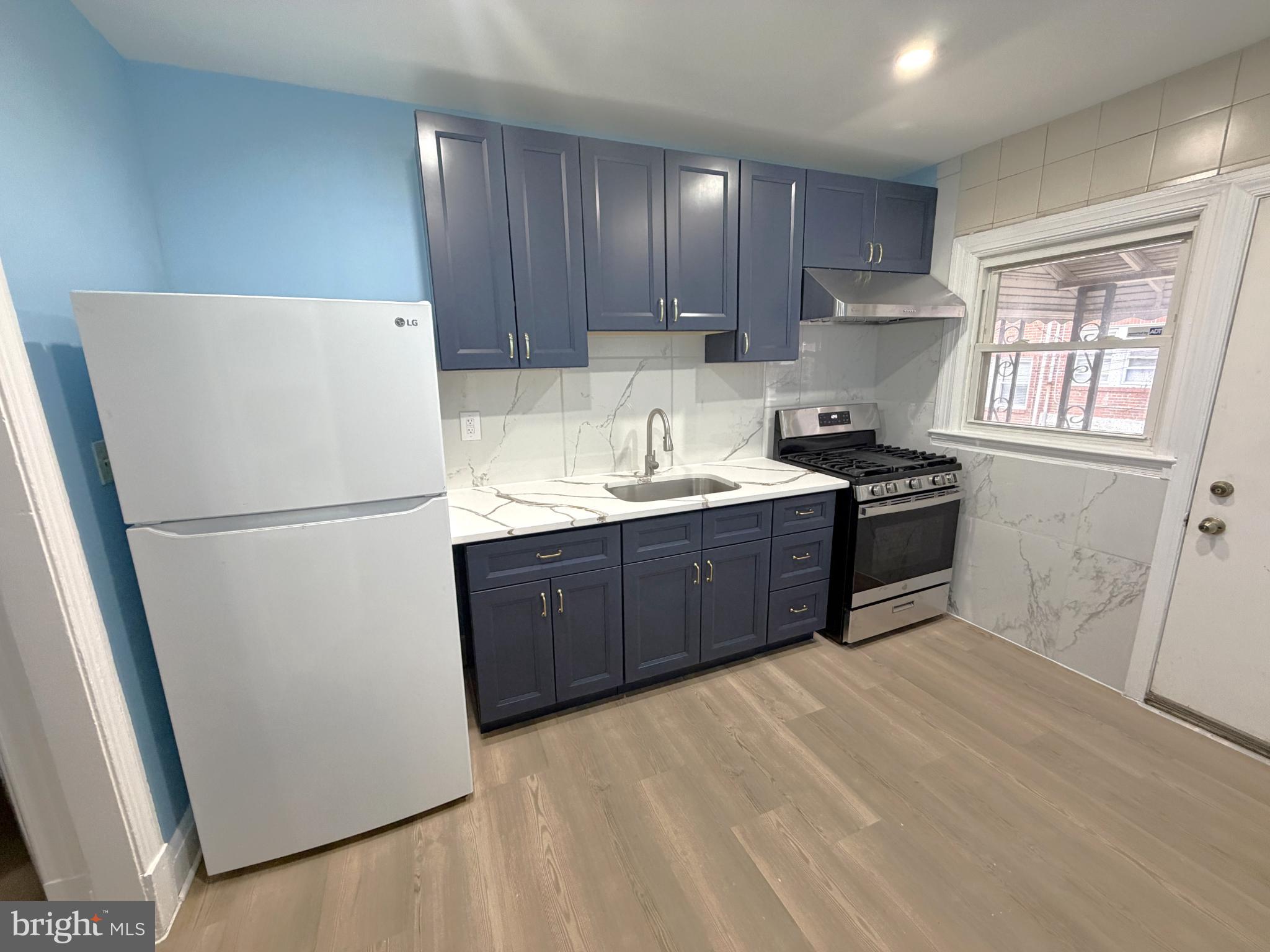 12 South Ellamont Street Baltimore, MD 21229 - Photo 5 of 26 a kitchen with stainless steel appliances granite countertop a refrigerator a sink dishwasher a stove top oven a refrigerator and cabinets