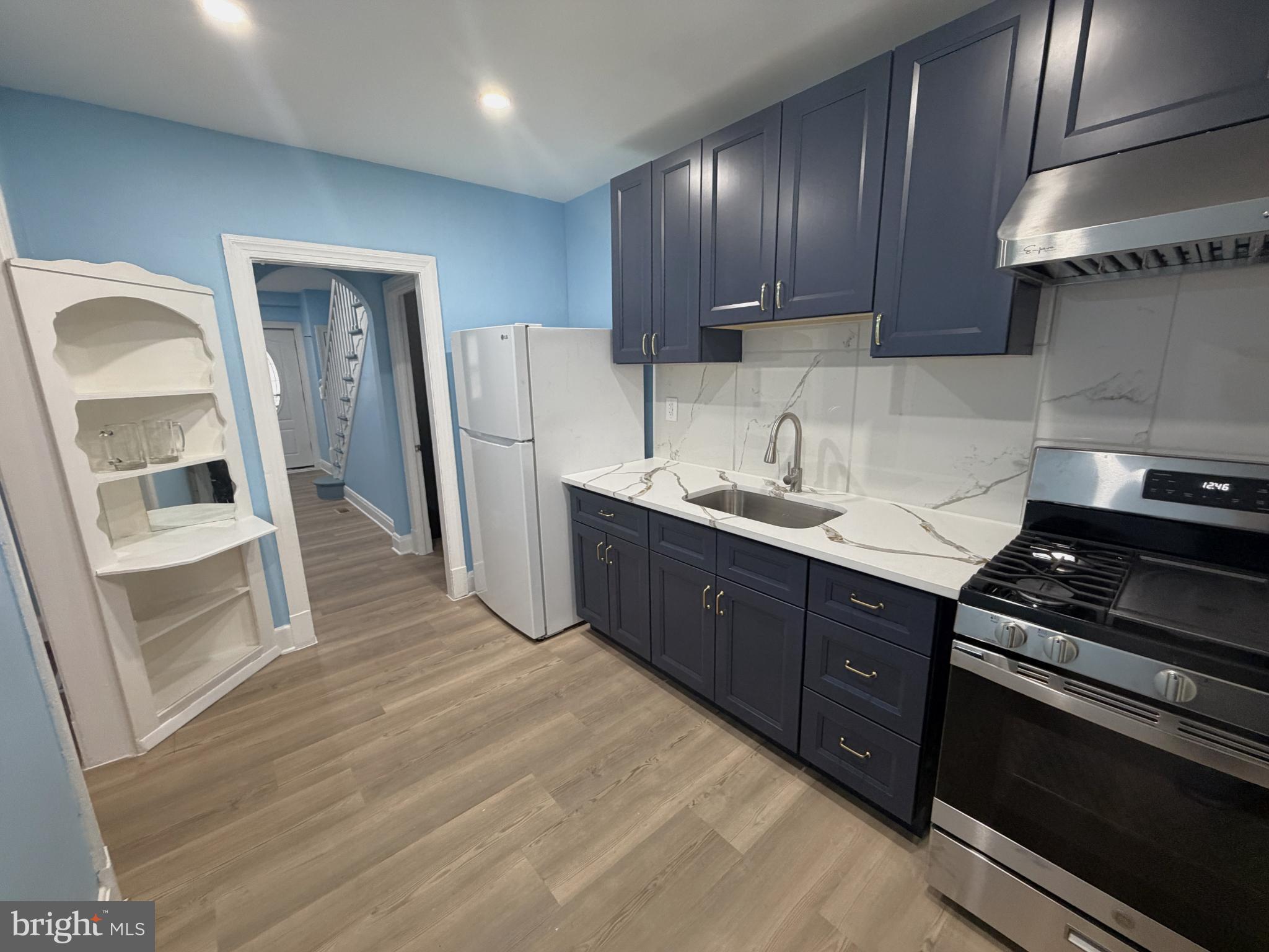 12 South Ellamont Street Baltimore, MD 21229 - Photo 6 of 26 a kitchen with stainless steel appliances granite countertop a stove a sink and a refrigerator