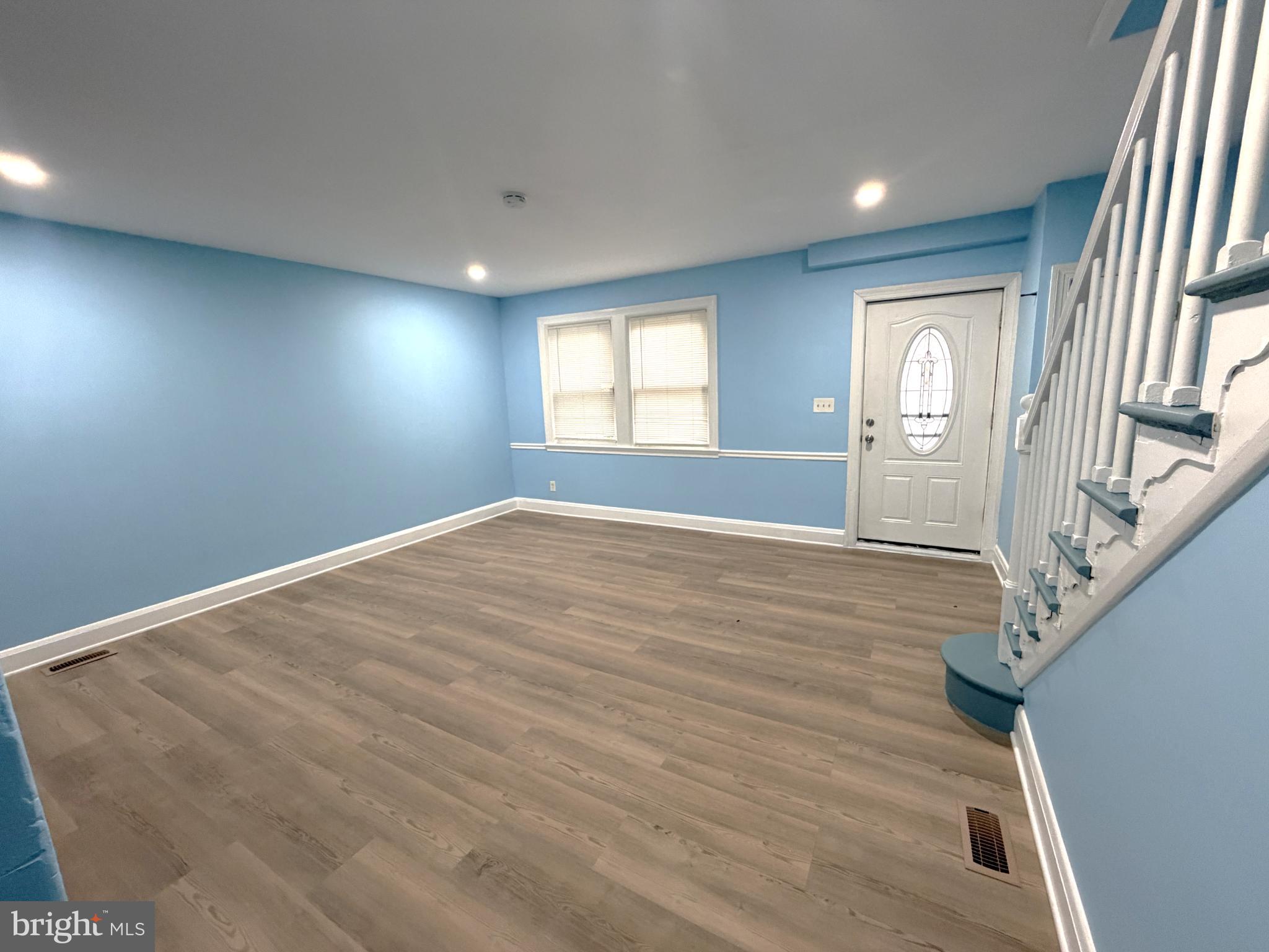 12 South Ellamont Street Baltimore, MD 21229 - Photo 7 of 26 an empty room with wooden floor and windows