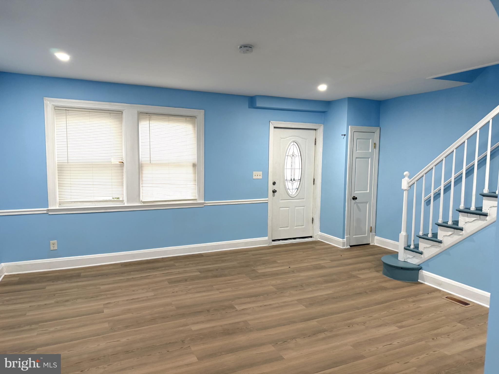 12 South Ellamont Street Baltimore, MD 21229 - Photo 9 of 26 a view of an empty room with wooden floor and a window