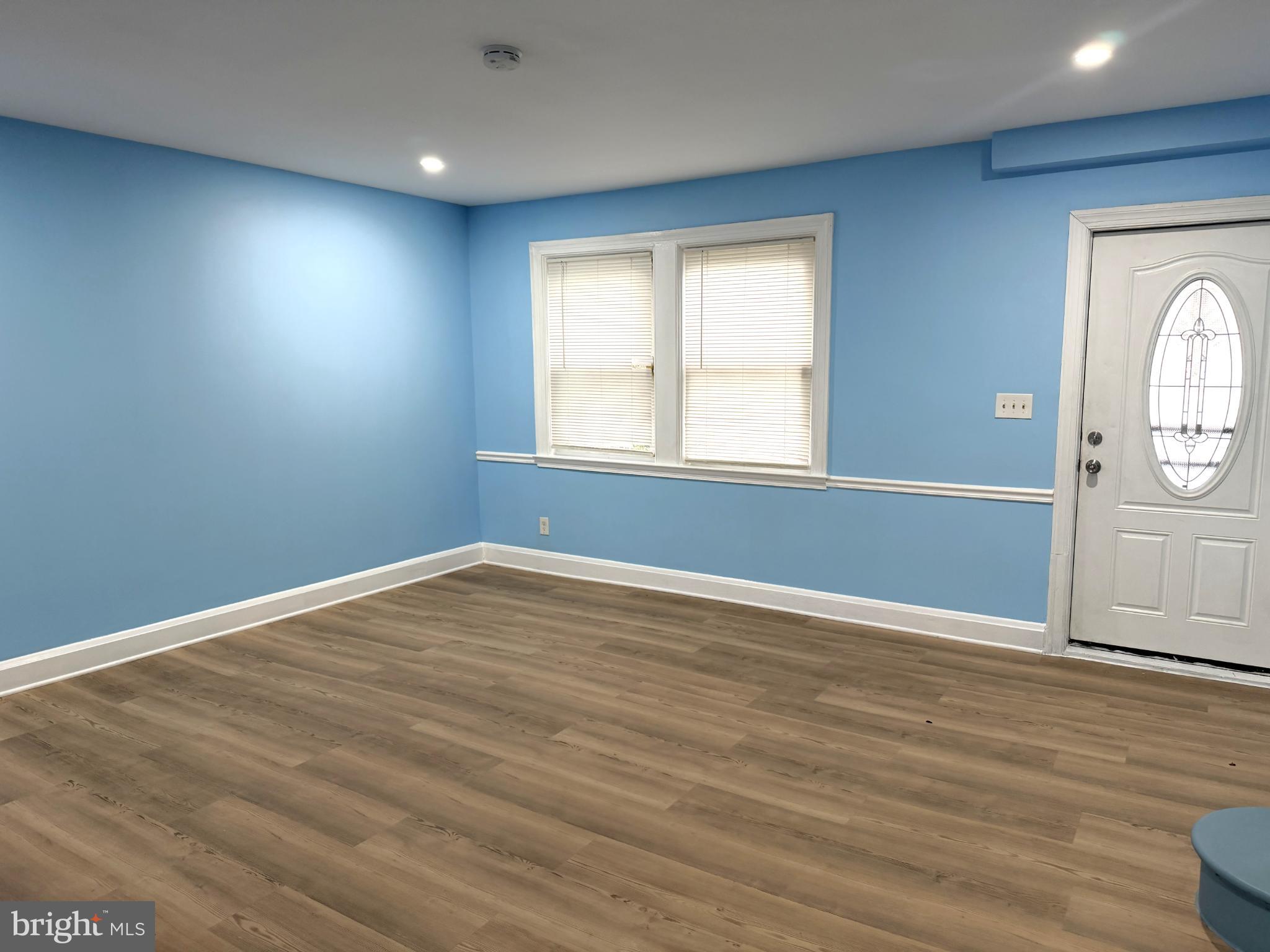 12 South Ellamont Street Baltimore, MD 21229 - Photo 10 of 26 an empty room with wooden floor and windows