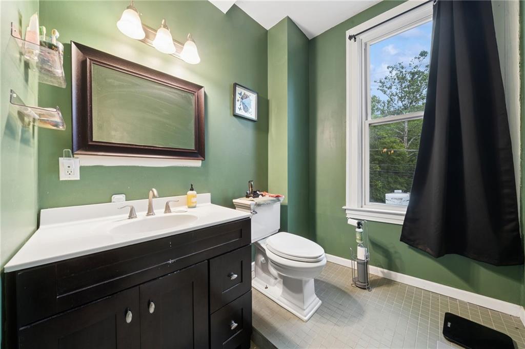 1523 Evergreen Road Pittsburgh, PA 15209 - Photo 26 of 35 a bathroom with a toilet sink and mirror