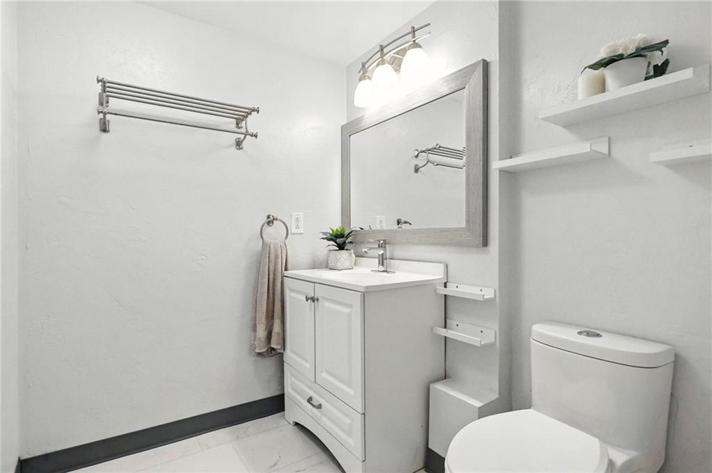 1335 Cardinal Drive Pittsburgh, PA 15243 - Photo 25 of 34 a bathroom with a sink mirror vanity and toilet