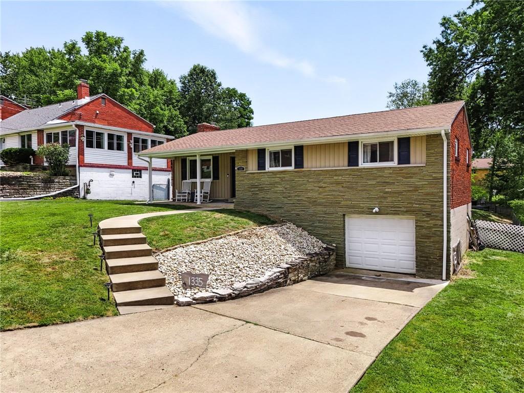 1335 Cardinal Drive Pittsburgh, PA 15243 - Photo 4 of 34 a front view of a house with a garden and yard