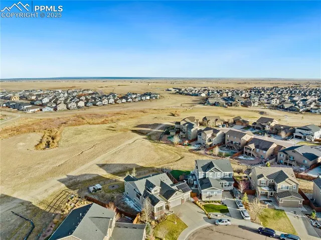 an aerial view of residential houses with outdoor space