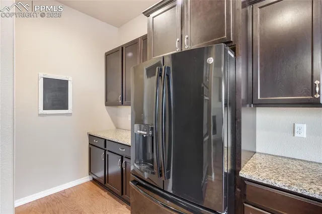 a kitchen with a sink chandelier and wooden floor