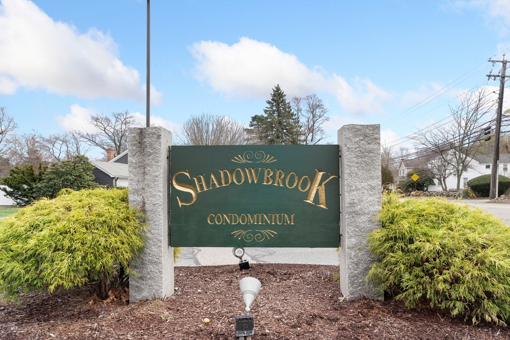 6 Shadowbrook Lane, Unit 9 Milford, MA 01757 - Photo 1 of 14 a sign on the side of the road