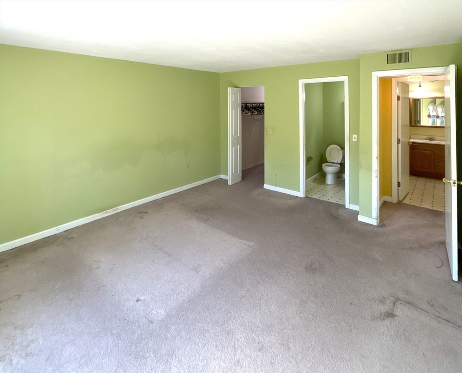 6 Shadowbrook Lane, Unit 9 Milford, MA 01757 - Photo 11 of 14 an empty room with closet and mirrors